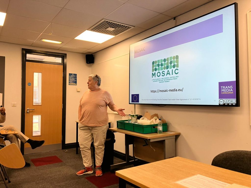 Pilar Orero presenting during the Industry-Academic Collaboration workshop at the EST Congress 2025, with the MOSAIC project website and logo displayed on the screen behind her.