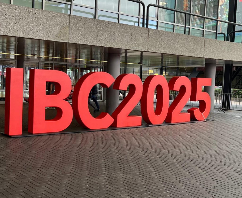 Large red letters spelling “IBC2025” displayed outside the Amsterdam RAI convention centre, where the MOSAIC Project was showcased.